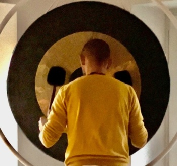 man playing on a huge gong